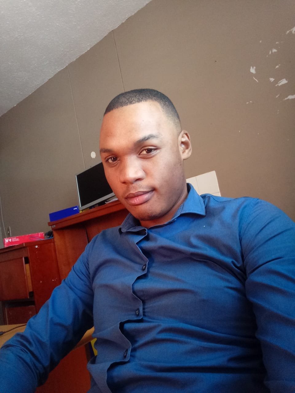 REV MKINO wearing a blue shirt